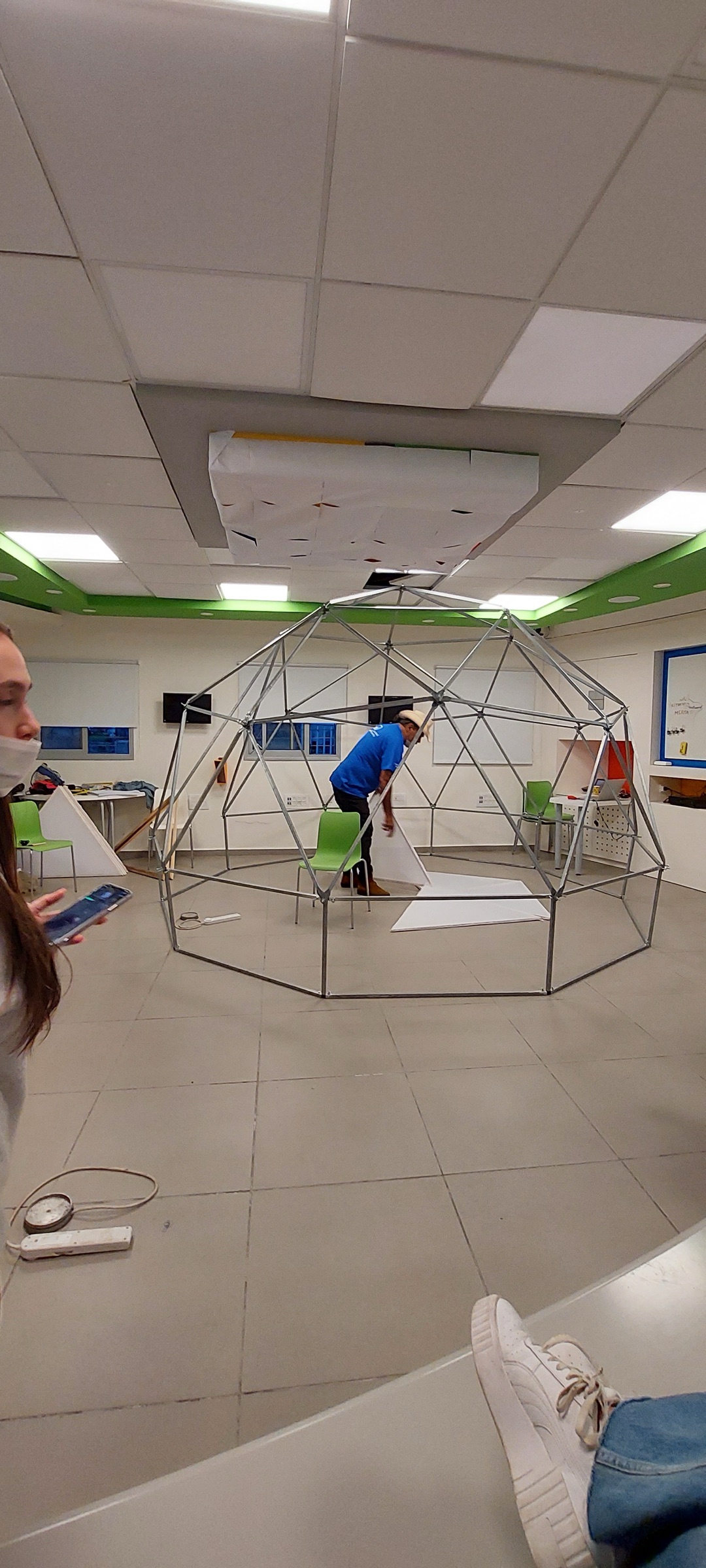 Volunteers assembling the geodesic frame of the Intel XR Dome panel by panel.