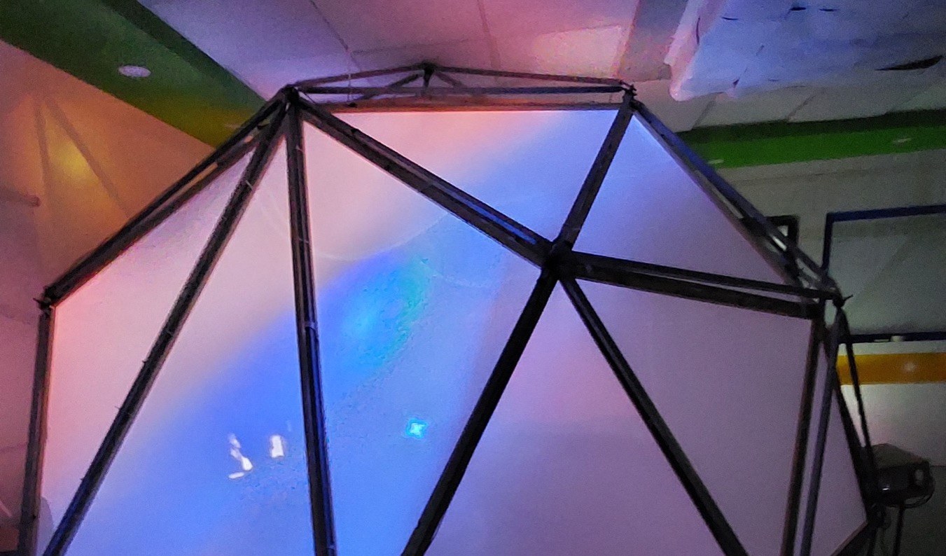 The Intel XR Dome lit up from inside with blue and purple interactive projection.